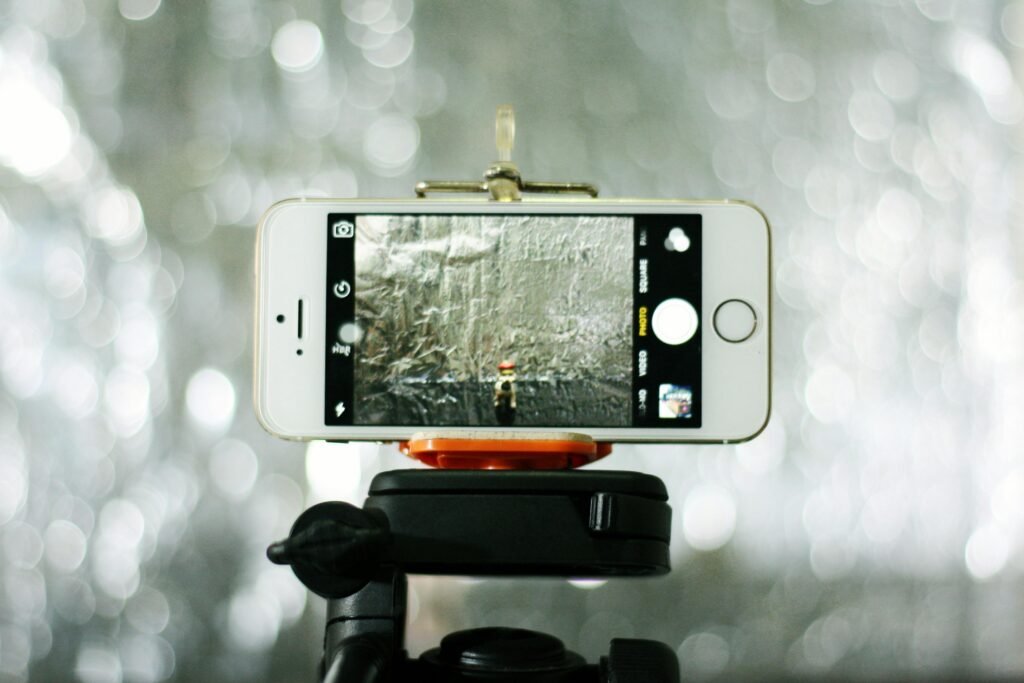 Close-up of a smartphone on a tripod, capturing an outdoor scene. Perfect for technology themes.